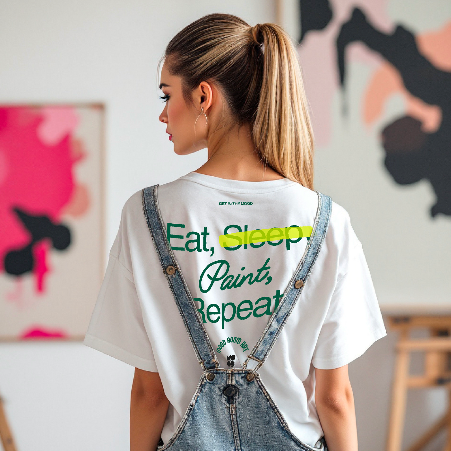 Model wearing a white graphic tee from The Mood Room, featuring bold wearable art for artists, creators, and expressive souls. Support local art in style.
