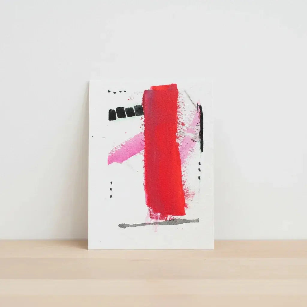 Abstract mini watercolor painting with bold red, pink, and black brushstrokes on white paper
